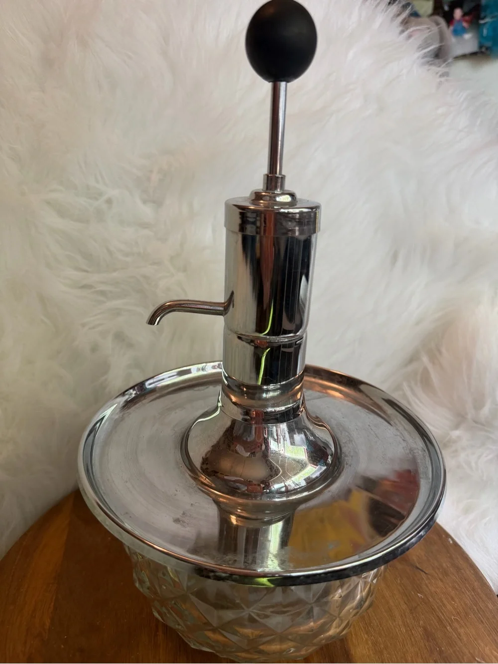 A vintage Park Sherman chrome and glass liquor dispenser with a metal tray.